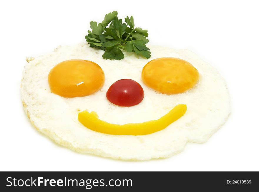 Eggs as a smiley face adorned with greenery on a white plate