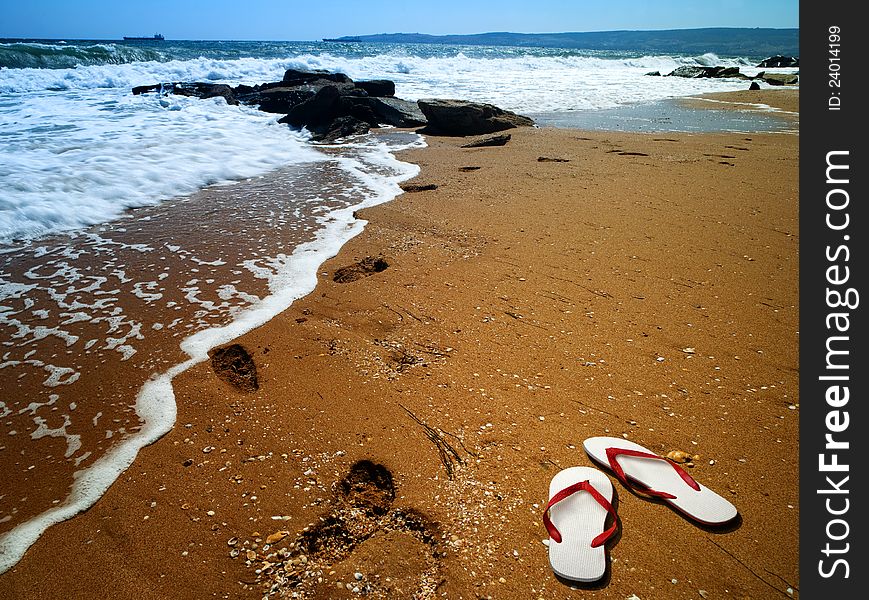 Sea Surf With Footprint Over Sand