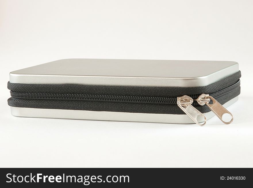 Silver metal box with zipper. Shot on a white background.