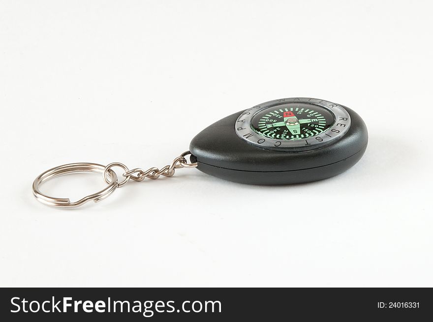 Plastic compass keychain. Shot on a white background.