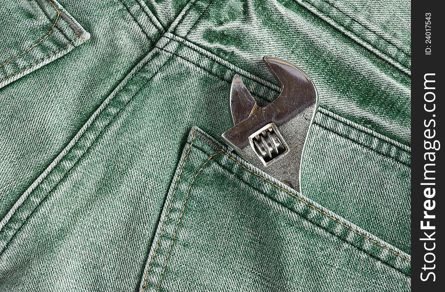 Green jeans pocket with old tool. Green jeans pocket with old tool