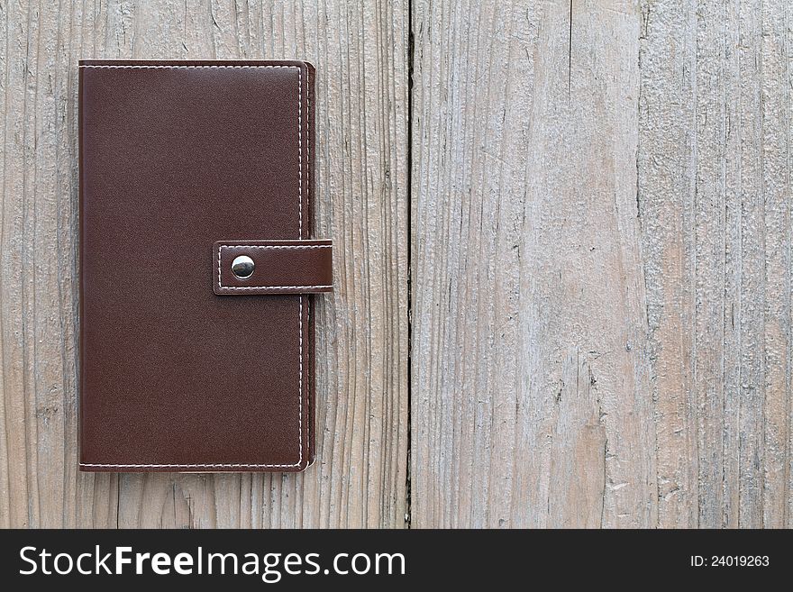 Brown personal notebook on wooden table. Brown personal notebook on wooden table