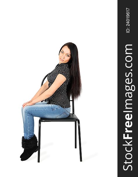 Beautiful Girl Wearing Jeans Sits On Chair