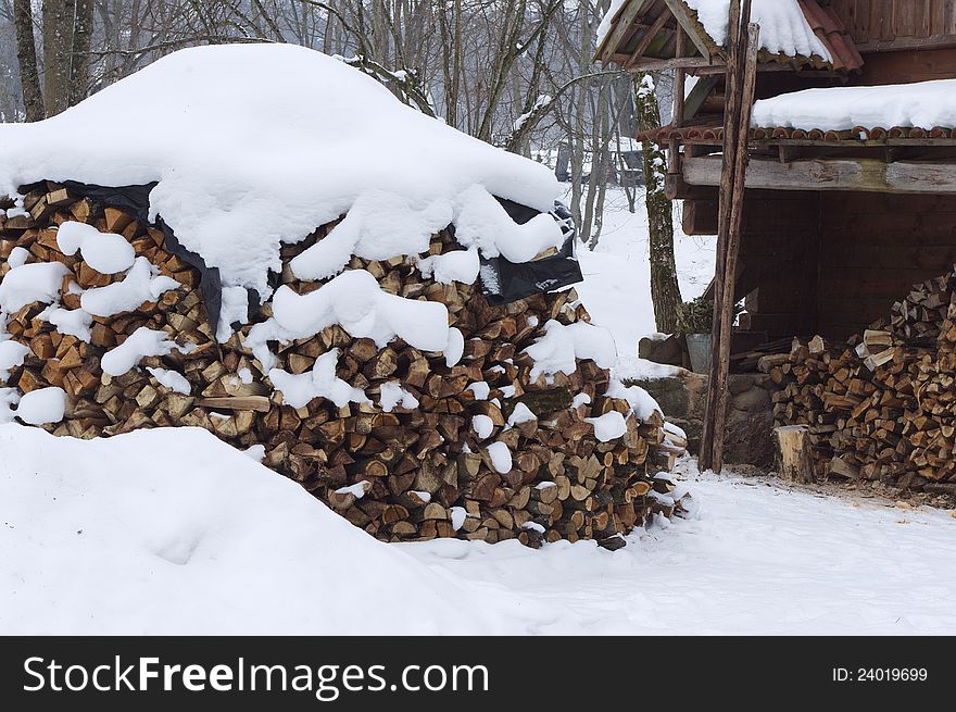Heap of wood near old cottage fuel for winter, closeup