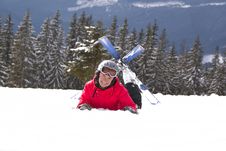 Girl Skier Lie On The Snow Royalty Free Stock Image