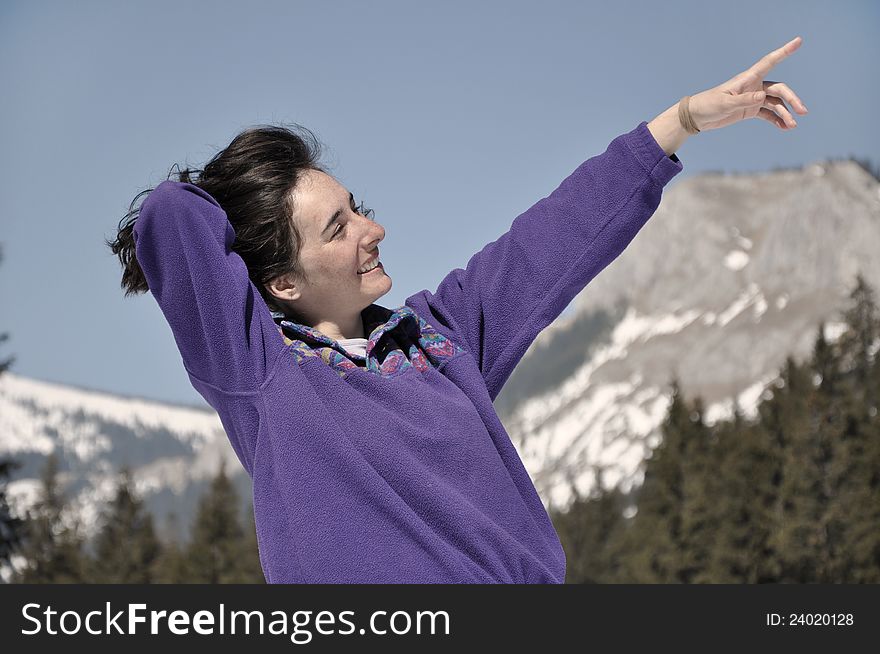 Young woman at winter in the mountains