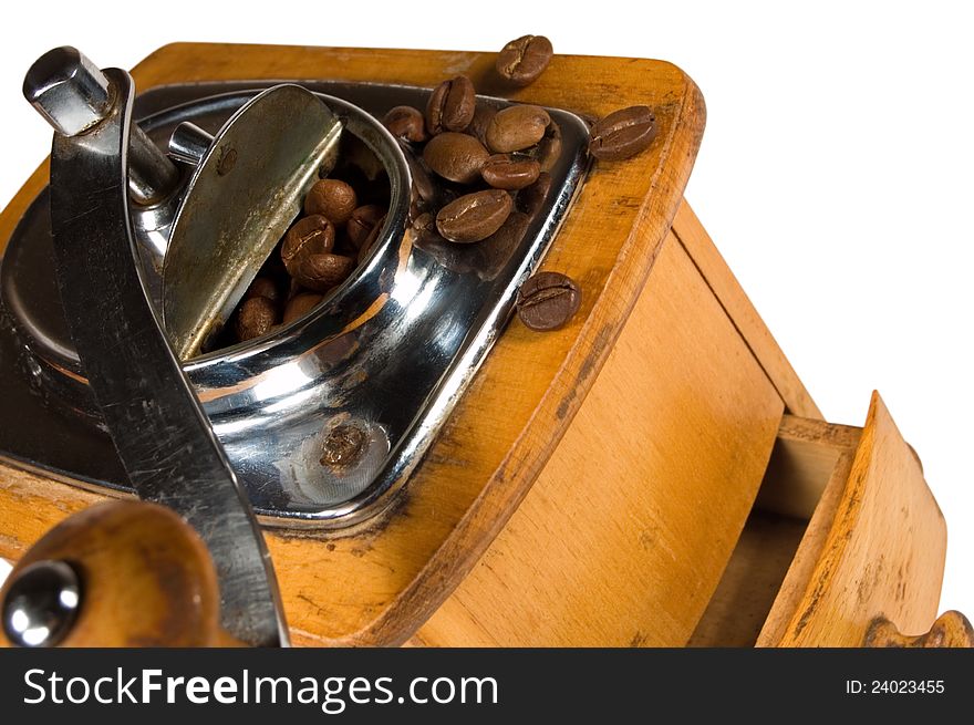 Old wooden coffee mill close-up on a white background