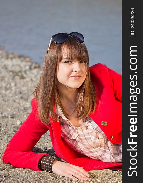 A girl in a bright red coat and sunglasses. A girl in a bright red coat and sunglasses