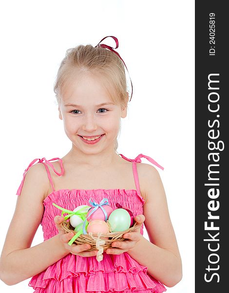 Cute smiling little girl holding Easter eggs in basket. Cute smiling little girl holding Easter eggs in basket