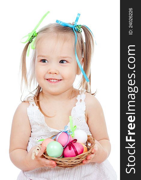 Cute smiling little girl holding Easter eggs in basket. Cute smiling little girl holding Easter eggs in basket