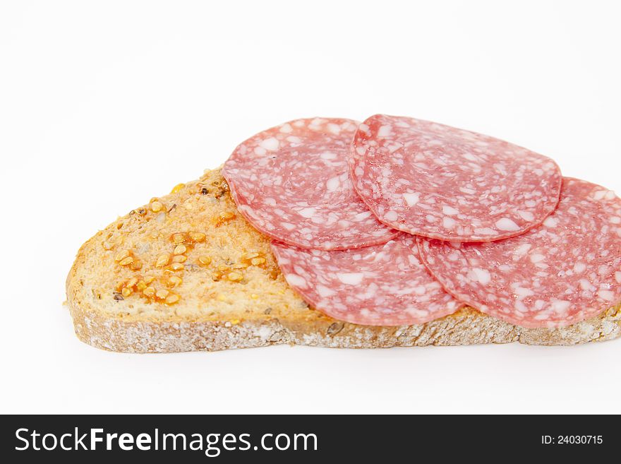 Seed bread with tomato and salami and white background. Seed bread with tomato and salami and white background