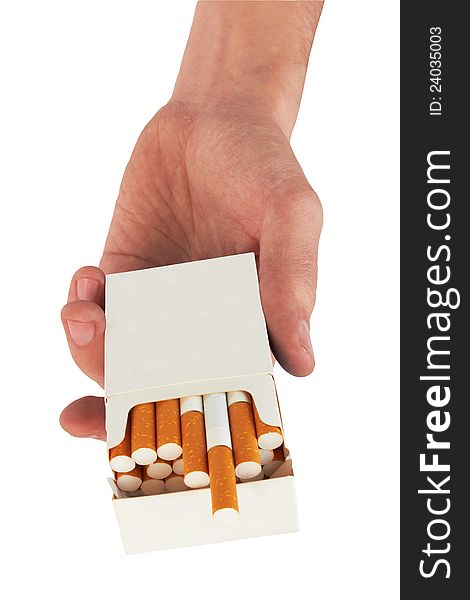 Pack of cigarettes in hand, isolated on white background