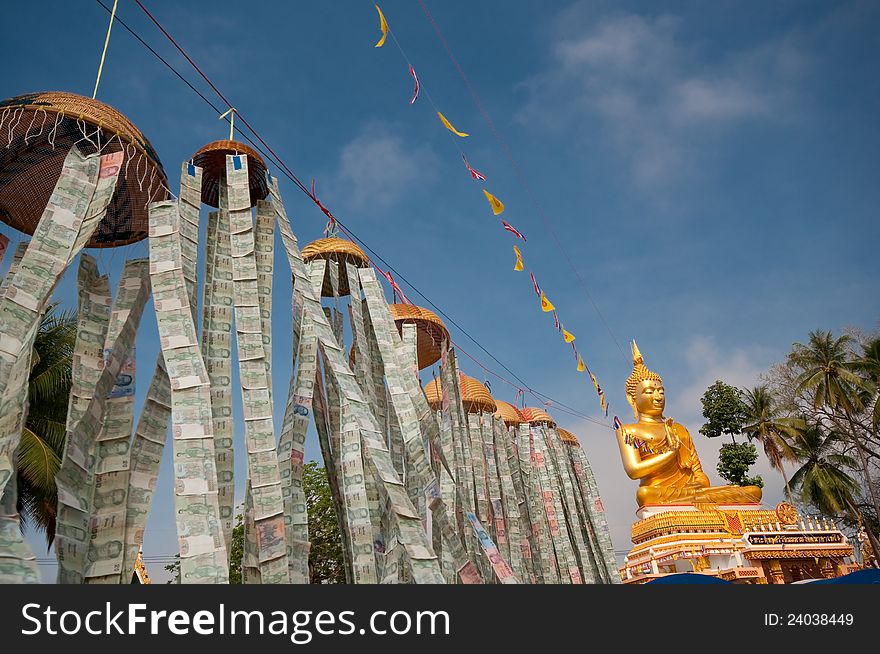 Beautiful exterior decoration in wat thai on holy day with line of flags and money lantern above the floor connecting to the big golden buddha image. Beautiful exterior decoration in wat thai on holy day with line of flags and money lantern above the floor connecting to the big golden buddha image.