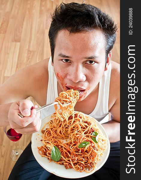Hungry man is eating spaghetti