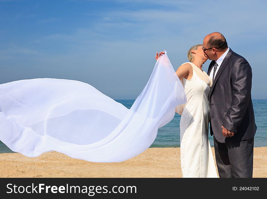 Beautiful couple kissing on the beach