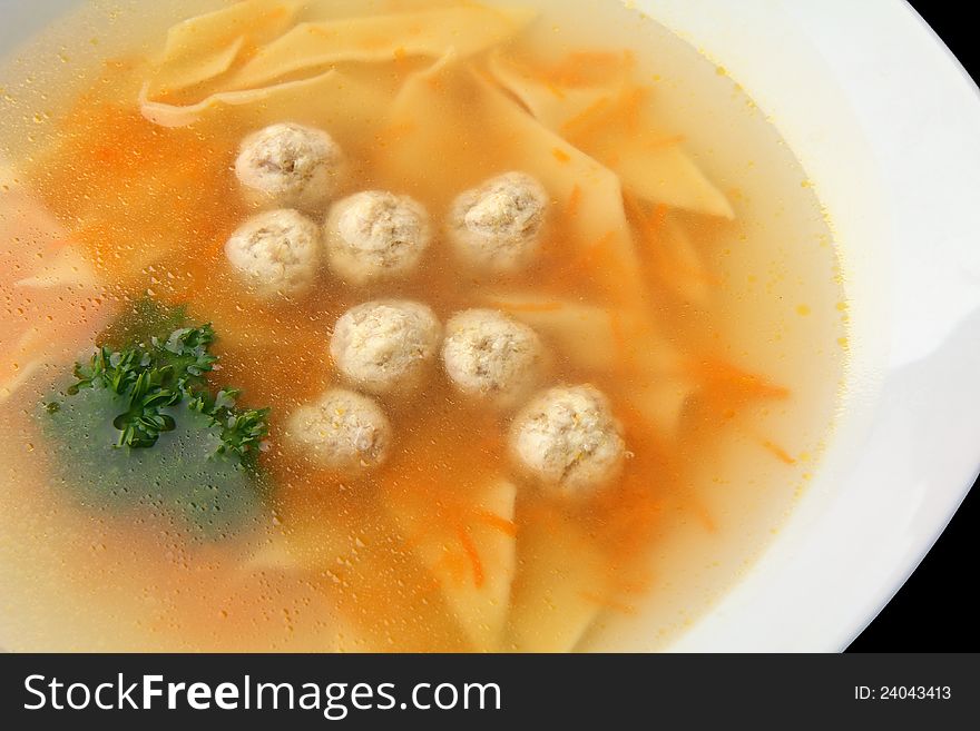 Chiken noodle soup with noisettes closeup