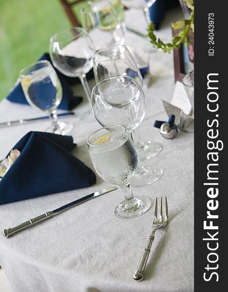 Detail of a wedding table with blue napkins and a glass of water. Detail of a wedding table with blue napkins and a glass of water