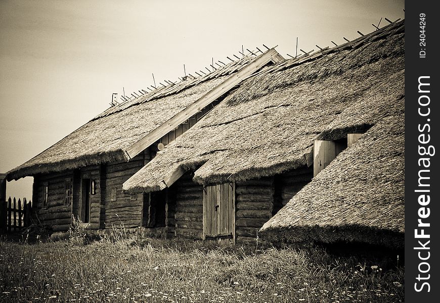 The old wooden houses with thatched roofs in the village