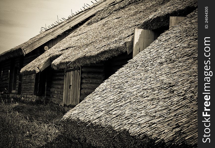 The old wooden houses with thatched roofs in the village