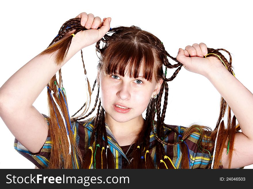 The teenage girl with plaits on a white background