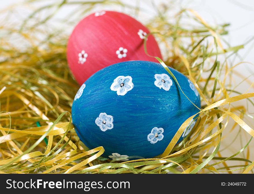 Painted blue and red easter egg with white flowers motifs. Handmade easter decoration. Painted blue and red easter egg with white flowers motifs. Handmade easter decoration.