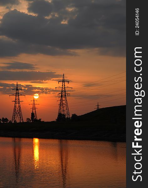 Sunset On The River. Electricity Power Line.