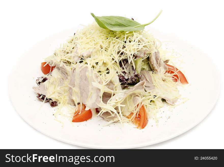 Meat salad with cheese and herbs on a white plate. Meat salad with cheese and herbs on a white plate