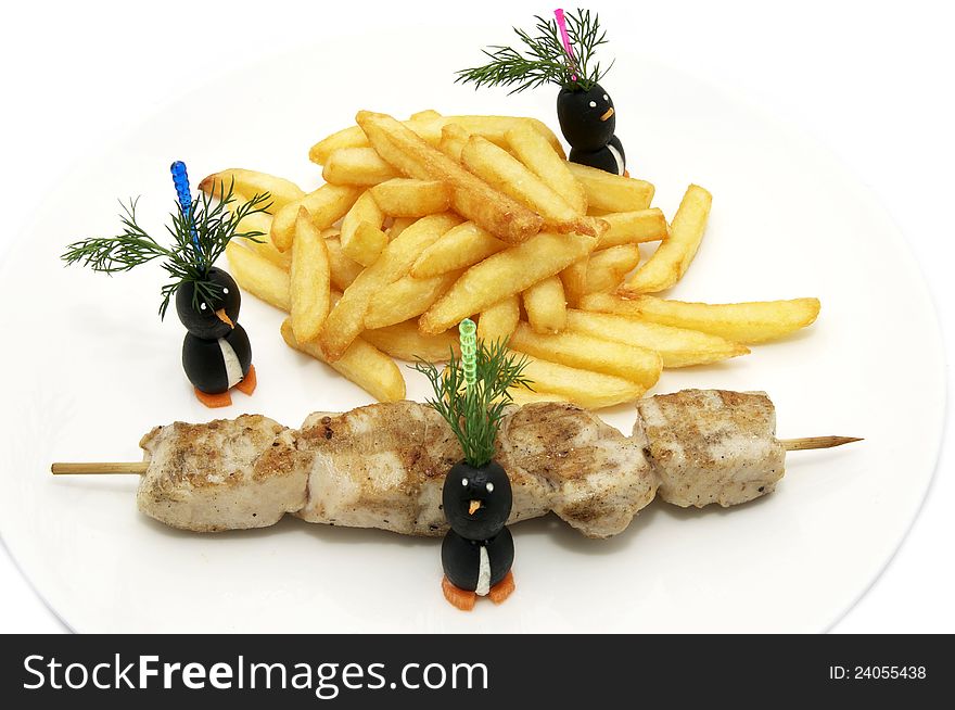 French fries and kebabs decorated with greenery on a white plate