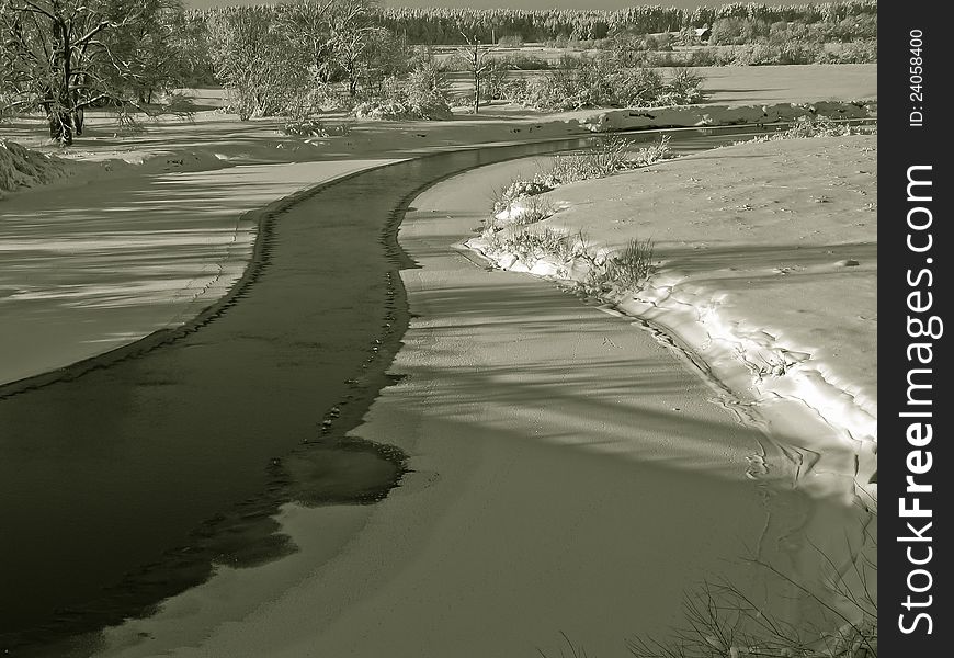 A beautiful winter scenery with views of the frozen river. A beautiful winter scenery with views of the frozen river