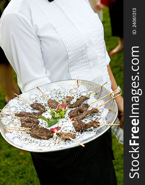 Appetizers being served by a waiter during a wedding or catered social event. Appetizers being served by a waiter during a wedding or catered social event