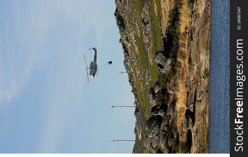 Firefighter helicopter in mission going to catch water