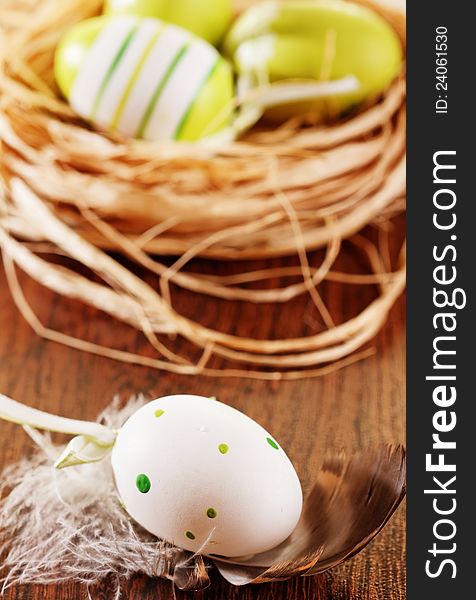 Colorful easter eggs on old nest on burlap background
