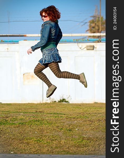 Young woman jumping high . Young woman jumping high .