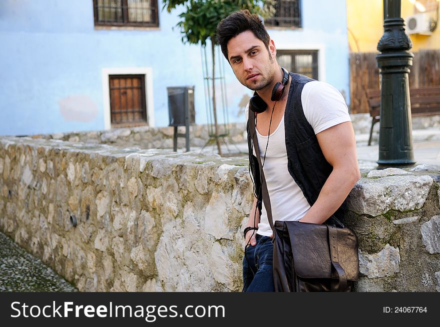 Portrait of young attractive man in urban background