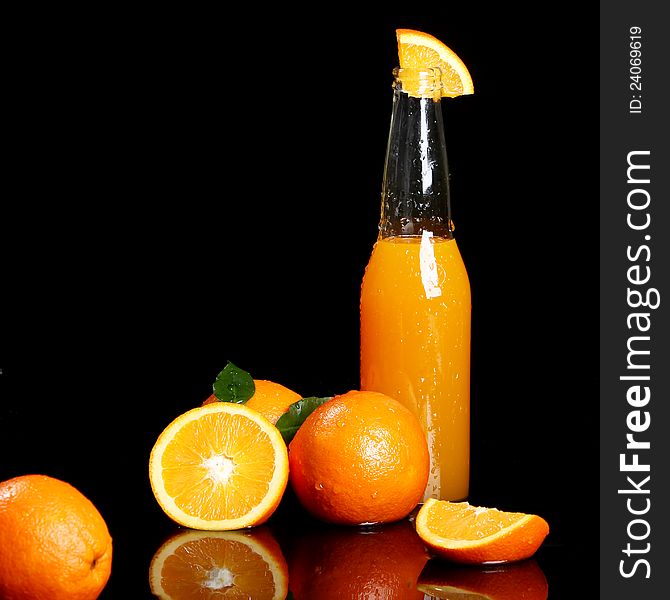 Fresh orange drink over black background