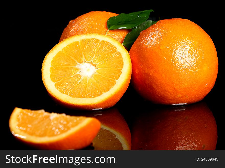 Close up of fresh orange fruit over black background