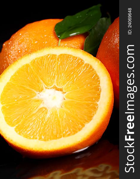Close up of fresh orange fruit over black background