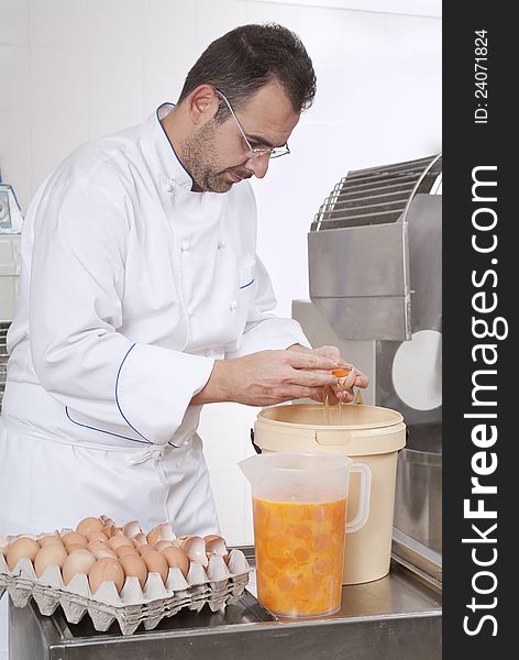 Pastry Chef prepares eggs dividing the Youk, put it in a jar. Pastry Chef prepares eggs dividing the Youk, put it in a jar
