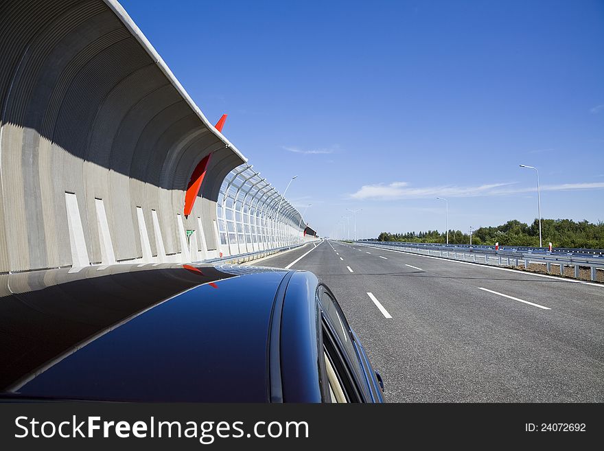 Empty highway with sound protection walls and car. Empty highway with sound protection walls and car