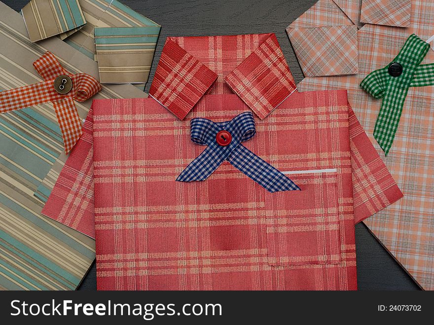 Gift pack of different papers, in the form of a shirt. Arranged horizontally. Close-up. Gift pack of different papers, in the form of a shirt. Arranged horizontally. Close-up.