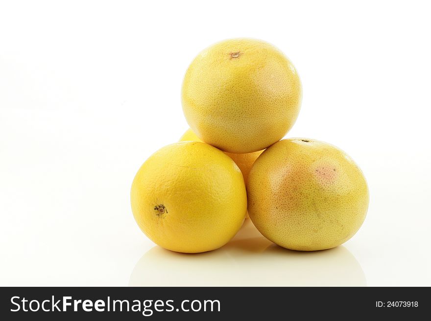 A stack of fresh whole grapefruits