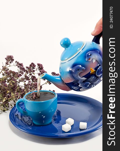 Tea and oregano in a blue service. Tea and oregano in a blue service