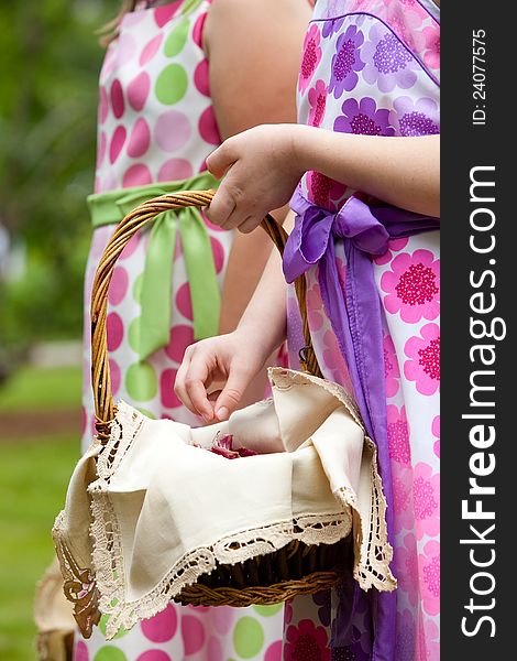 A flower girl holding a basket full of flower petals