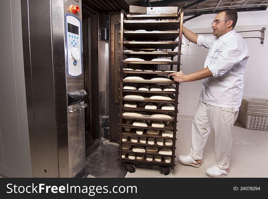 Baker makes the bread kneaded in the oven