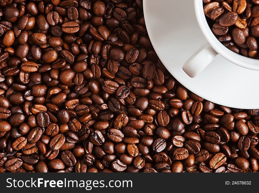 Coffee Beans With A Cup Filled With Coffee Beans