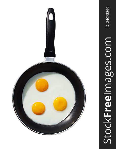 Three fried eggs in a frying pan,  on white background