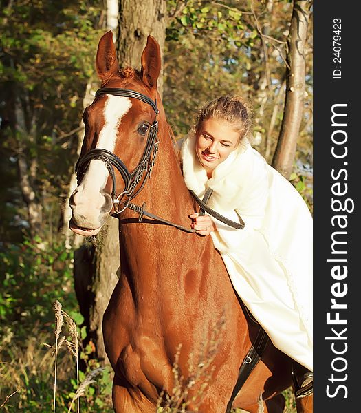 Young bride ride with horse sunny evening. Young bride ride with horse sunny evening