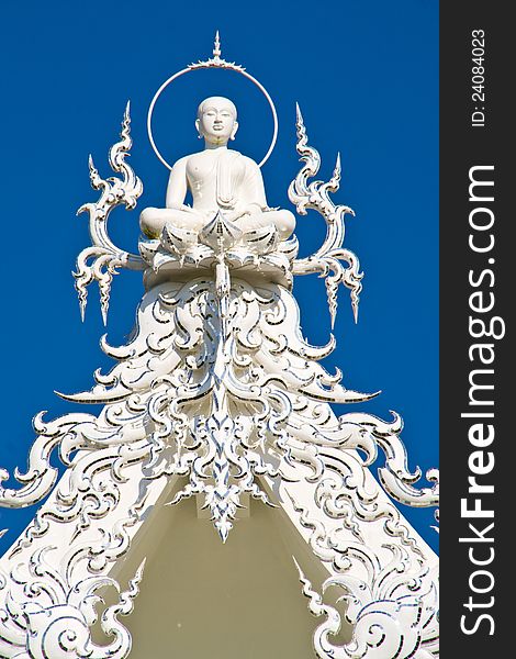 buddha on top of white chruch