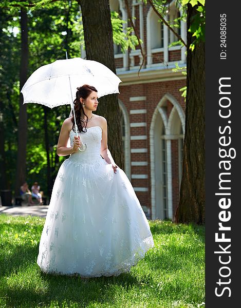 Happy bride in park in wedding walk. Happy bride in park in wedding walk