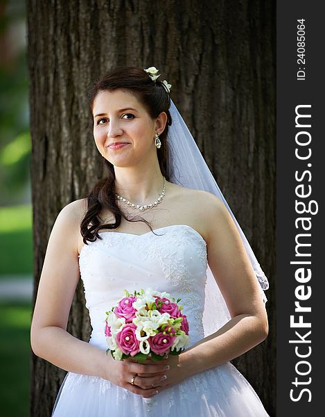 Happy bride with bouquet in wedding walk